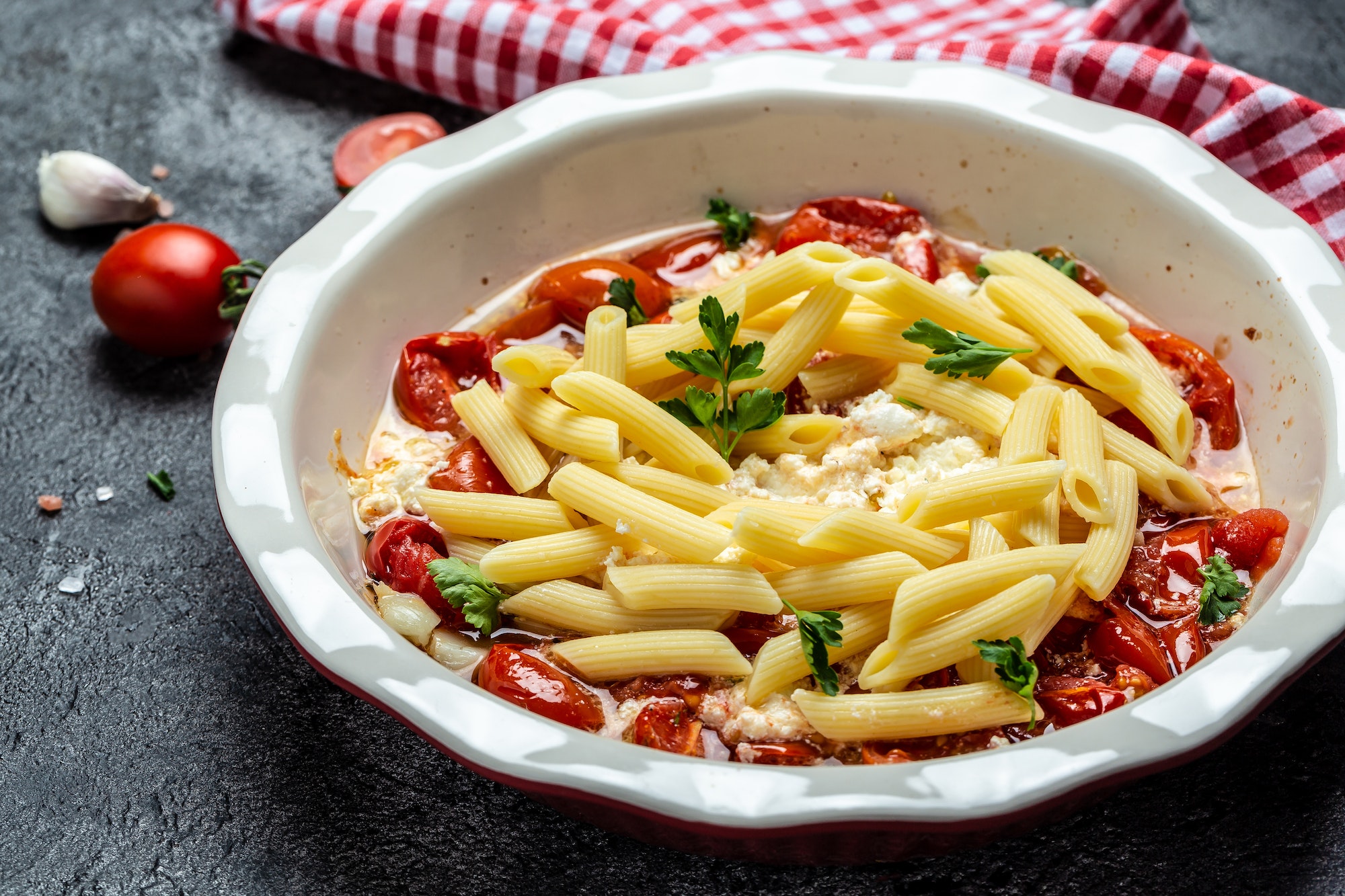 Cooking baked feta pasta with cherry tomatoes herbs and garlic, Trending Feta pasta recipe