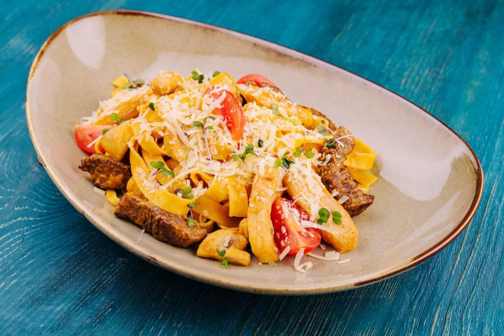Fettuccine pasta with beef, chicken and parmesan