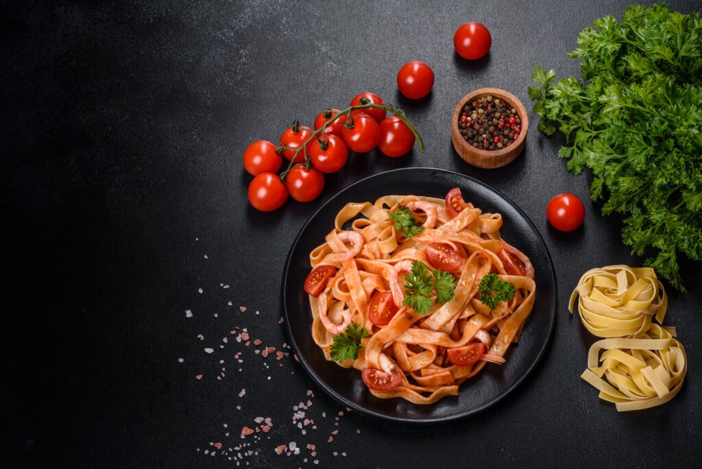 Fettuccine pasta with shrimp, cherry tomatoes, sauce, spices and herbs