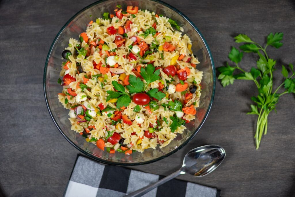 Homemade fresh pasta salad with fresh vegetables and herbs