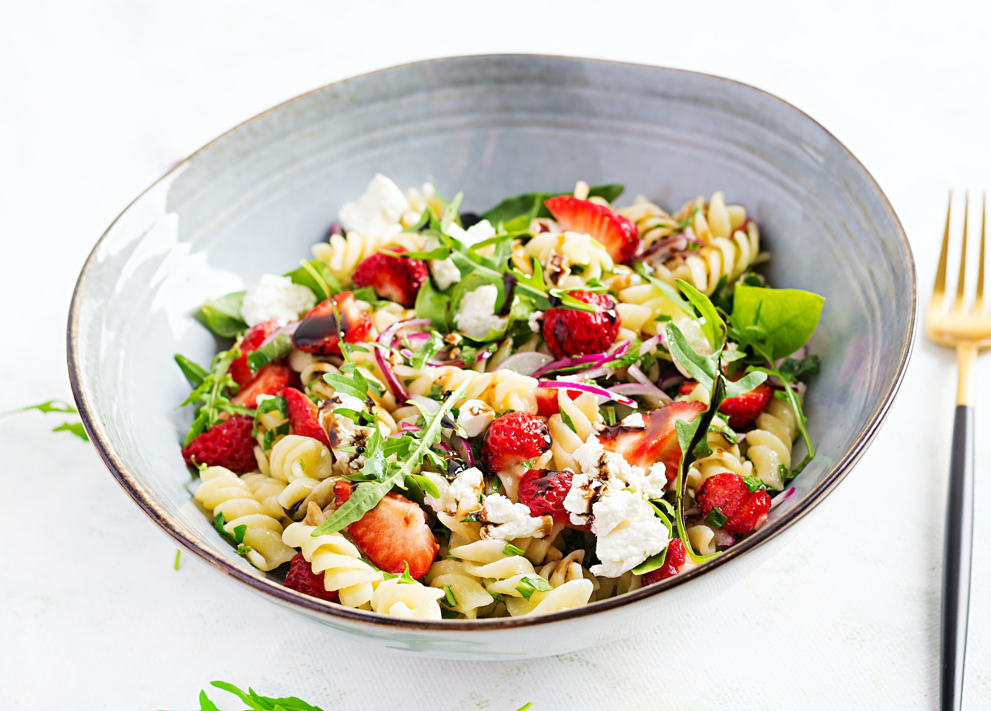 Pasta salad. Fusilli Pasta - salad with strawberry, feta cheese, red onion and balsamic sauce.