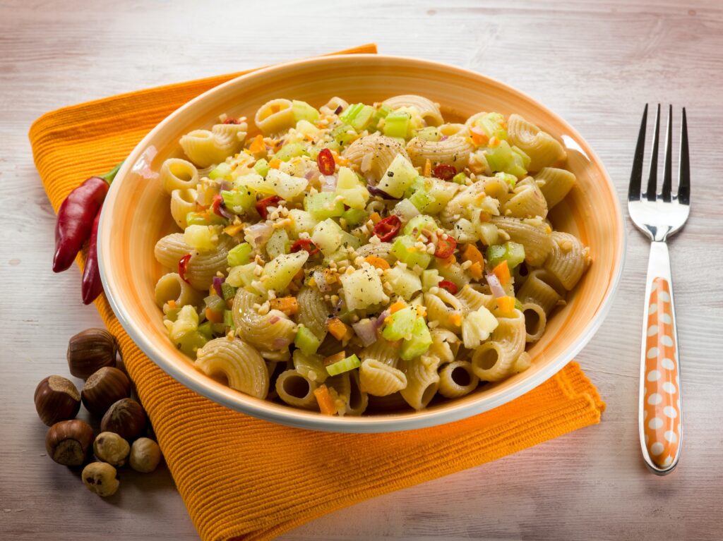 vegetarian pasta with pineapple carrot hot chili pepper and hazelnut